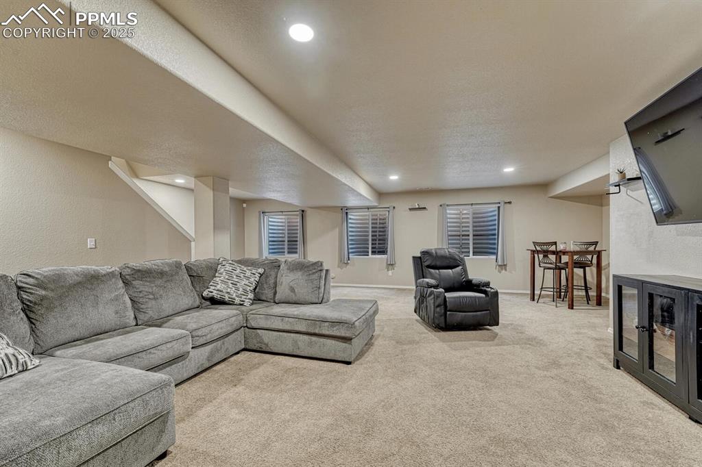 Image 23 of 41: Experience the warmth and comfort of a carpeted living area, perfectly comp