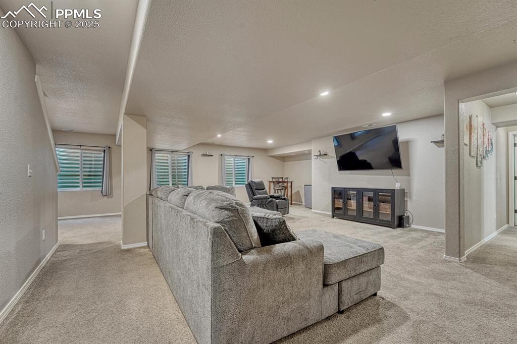 Image 24 of 41: Experience the warmth and comfort of a carpeted living area, perfectly comp