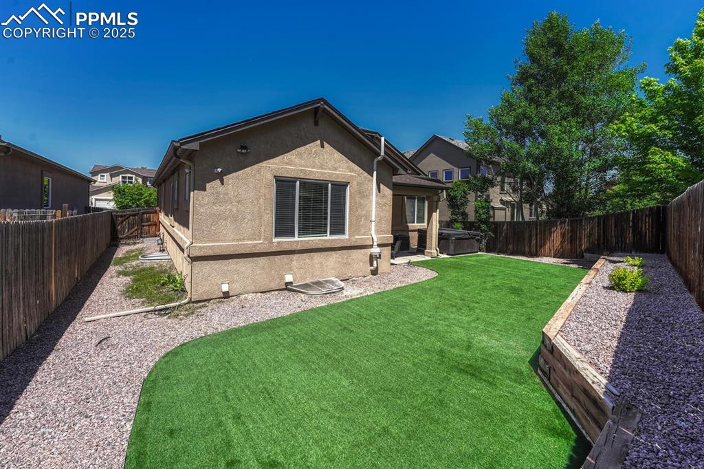 Image 36 of 41: The back of the house presents a tranquil atmosphere, with amenities like a