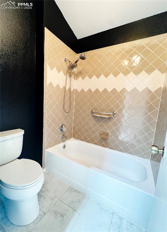 Image 13 of 28: Full bathroom with shower / bath combination and tile patterned flooring