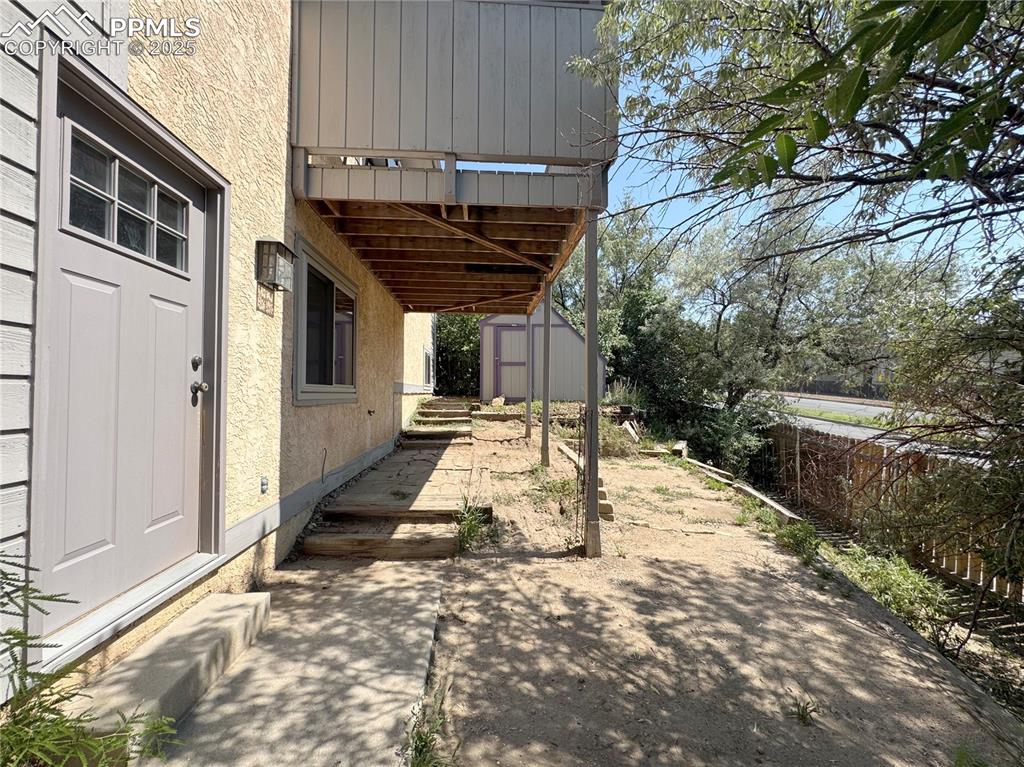 Image 25 of 28: View of patio with a storage unit