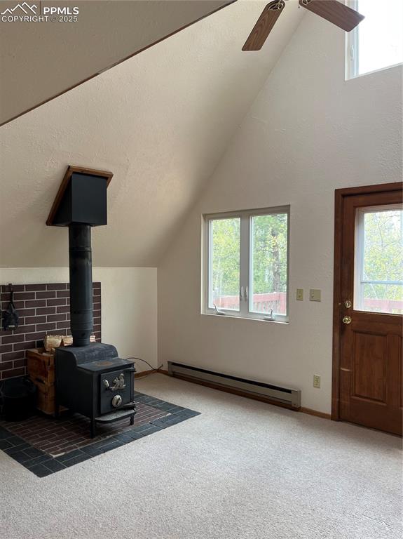 Image 4 of 13: Sports a nice wood stove and walk out to deck 