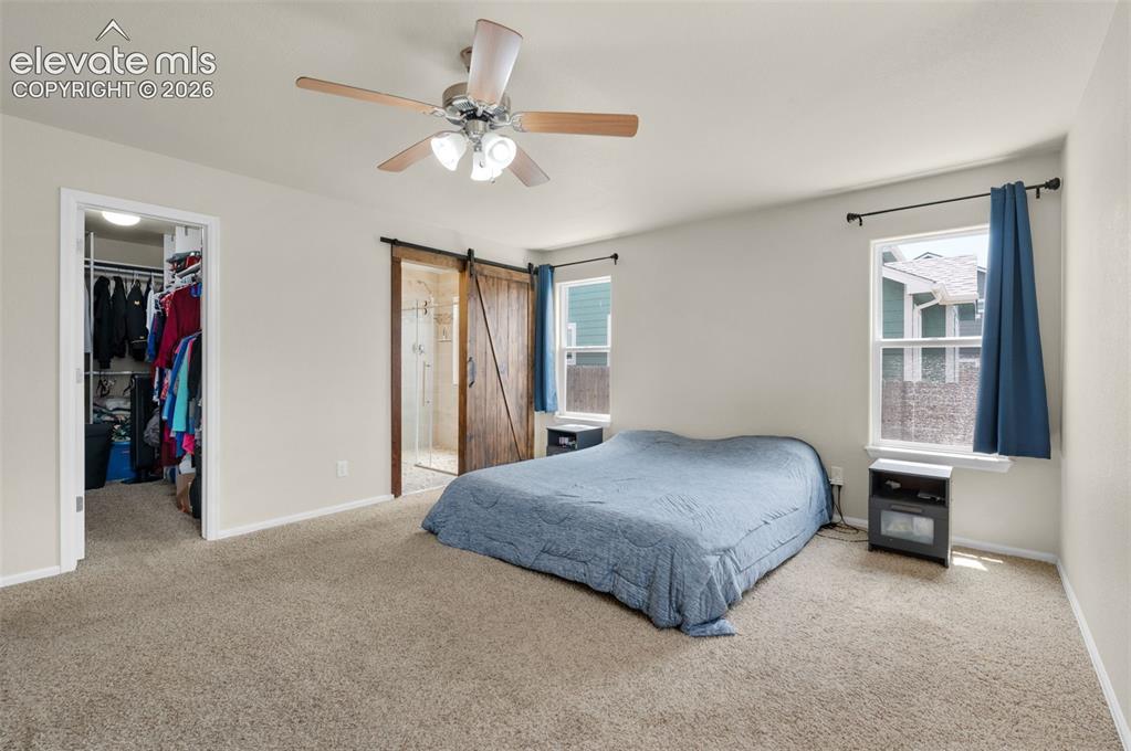 Image 21 of 50: Main level Primary Bedroom with large Walk in Closet