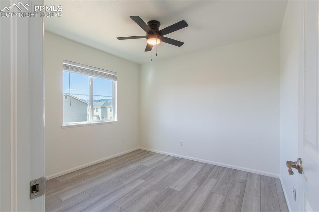 Image 26 of 41: Room featuring wood-finish flooring, a ceiling fan with integrated lighting