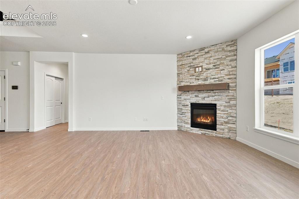 Image 11 of 49: The Great Room features a Gas fireplace with stone extended to the ceiling,