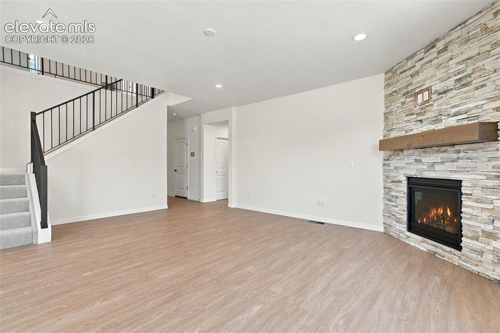 Image 13 of 49: he Great Room features a Gas fireplace with stone extended to the ceiling,