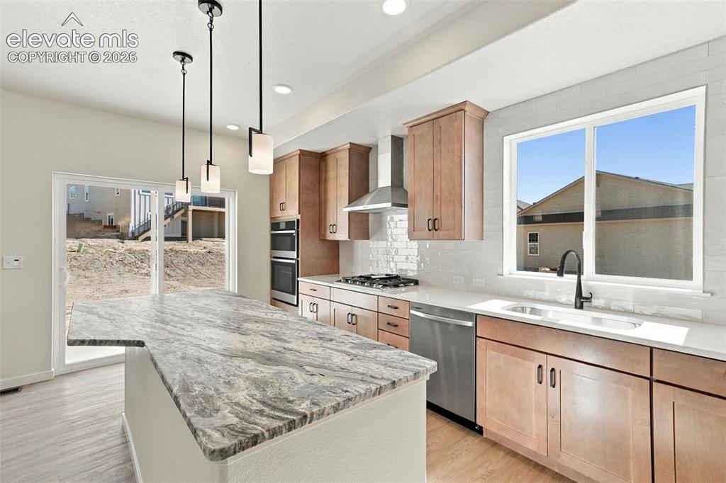 Image 16 of 49: Modern kitchen featuring stainless steel appliances, light maple cabinets w