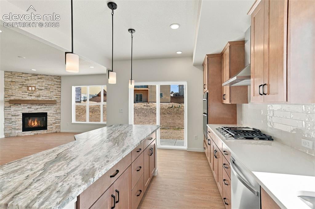 Image 19 of 49: Modern kitchen featuring stainless steel appliances, light maple cabinets w