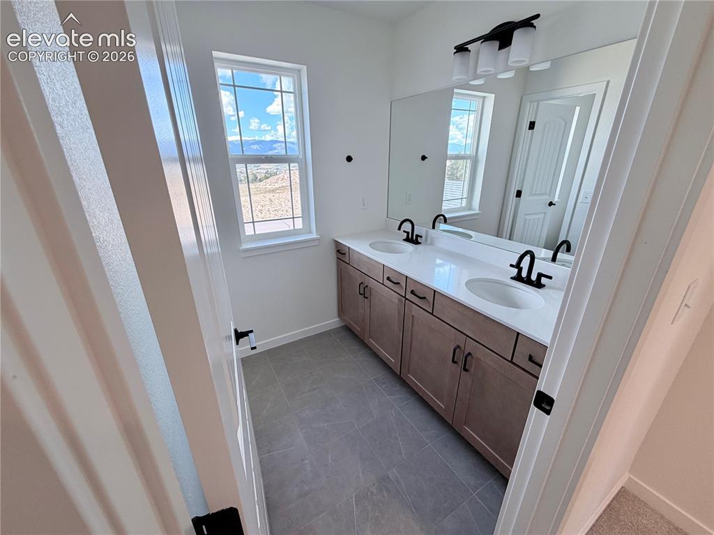 Image 31 of 46: Full Hall Bath with Double Sinks