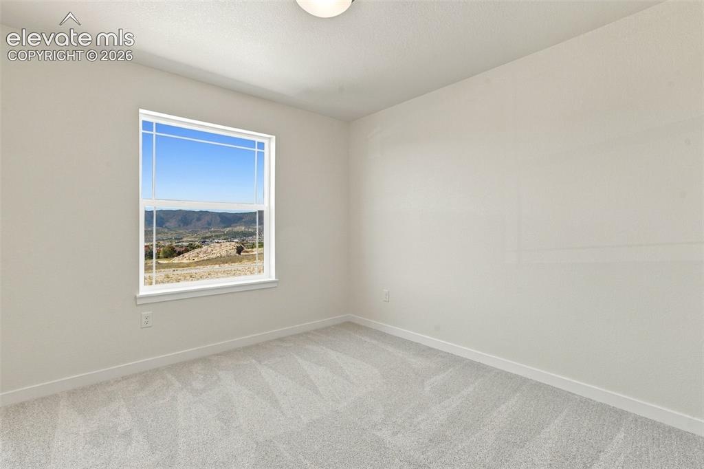 Image 33 of 49: Bedroom 3 features with soft white walls and plush gray carpeting