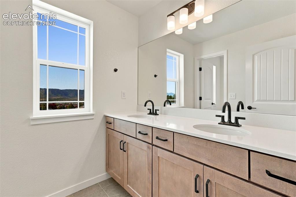 Image 35 of 49: The Full Hall Bath Includes a double vanity with undermount sinks, and a tu