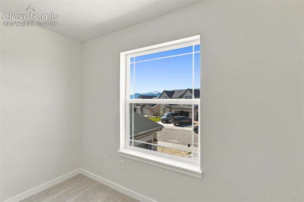 Image 37 of 49: Bedroom 4 features with soft white walls and plush gray carpeting