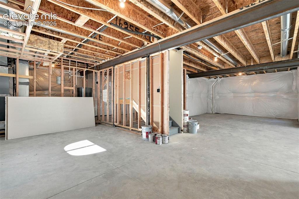 Image 42 of 49: Unfinished basement with exposed ceiling joists, and concrete flooring