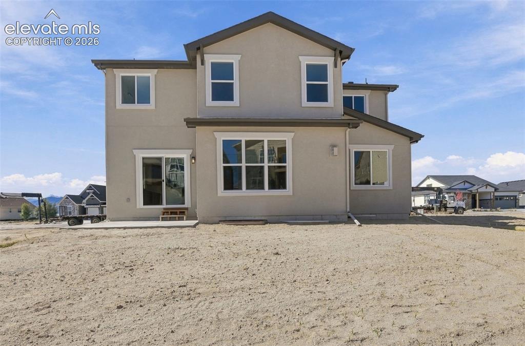 Image 46 of 49: Contemporary two-story with stucco exterior and a sliding glass door walkin