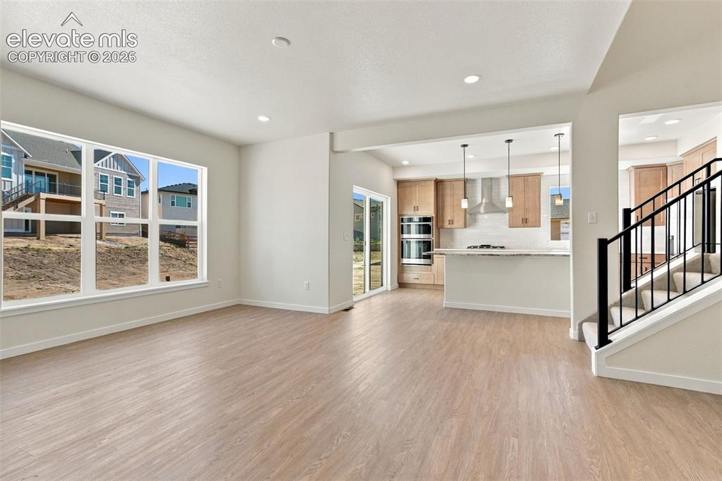 Image 9 of 49: Recessed lighting, wood-finish flooring, kitchen with light wood cabinetry,