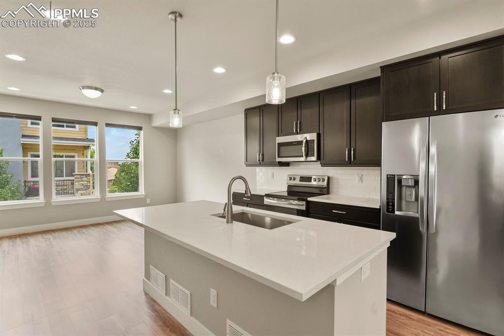 Image 11 of 29: Open concept kitchen and living room with tons of natural light