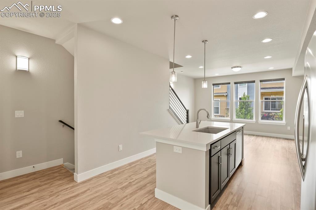 Image 12 of 29: Open concept kitchen and living room with tons of natural light