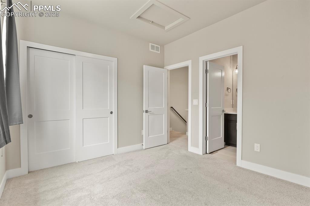Image 22 of 29: 2nd bedroom on upper level, nice deep closet and private full bathroom