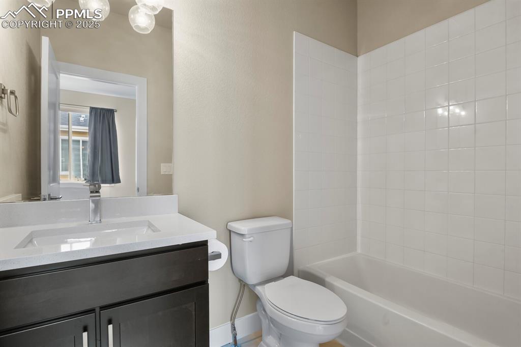 Image 23 of 29: Full bathroom with vanity and bathtub / shower combo