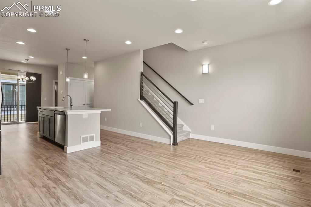 Image 8 of 29: Open concept between kitchen and living room