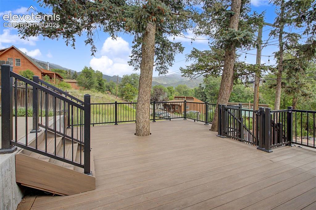 Image 7 of 27: Expansive composite deck featuring black metal railings and integrated matu