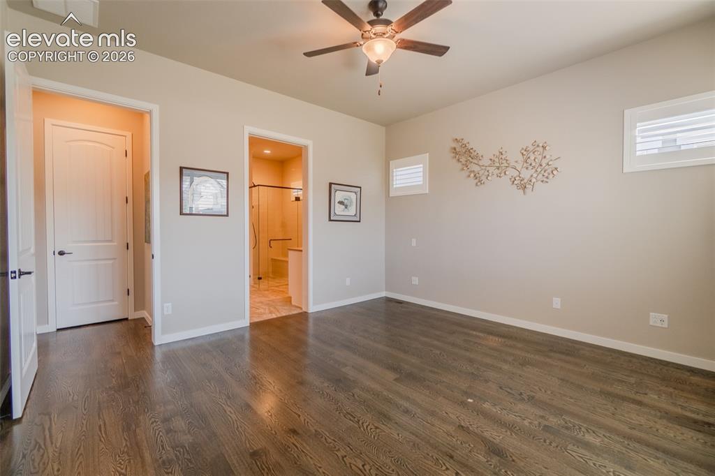 Image 27 of 50: Bedroom featuring wood-finish flooring, a ceiling fan with integrated light
