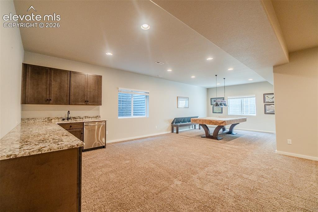 Image 33 of 50: Entertainment room featuring recessed lighting, plush carpet flooring, a we
