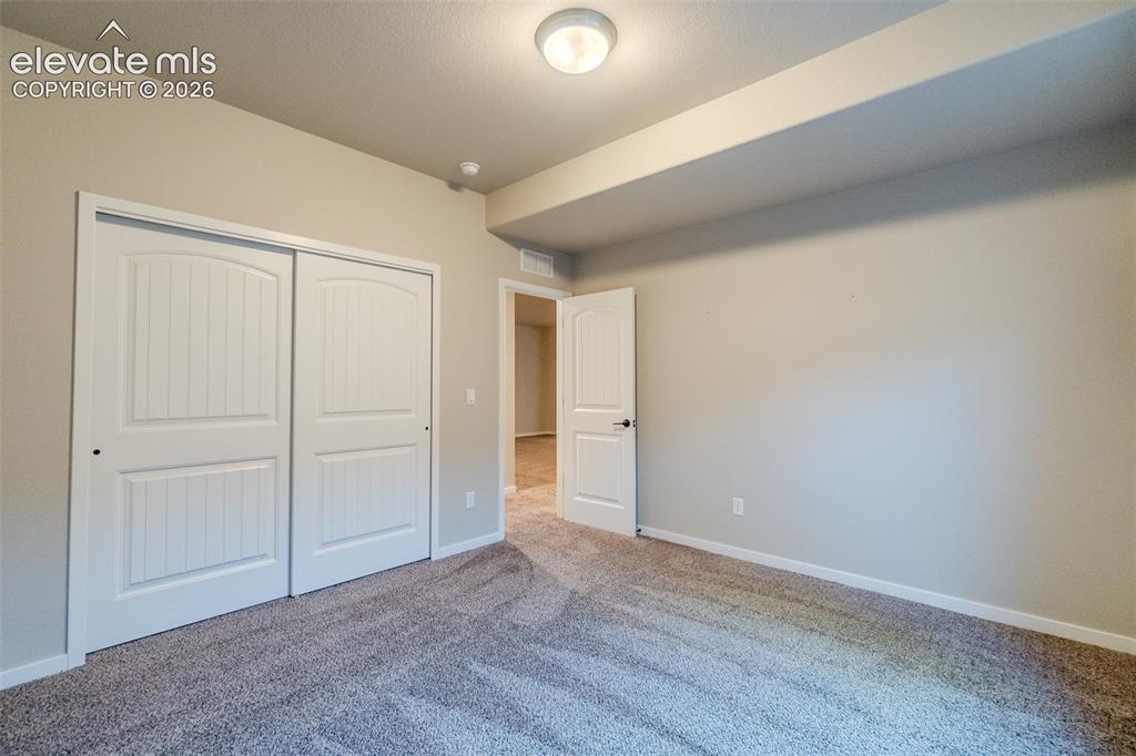 Image 44 of 50: Neutral tone walls with white trim throughout