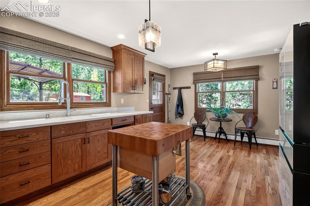 Image 14 of 50: Open concept dining area with vaulted wood beamed ceilings 