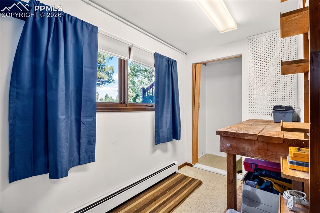 Image 32 of 50: Laundry room with utility sink, window and a play area or storage to the ri