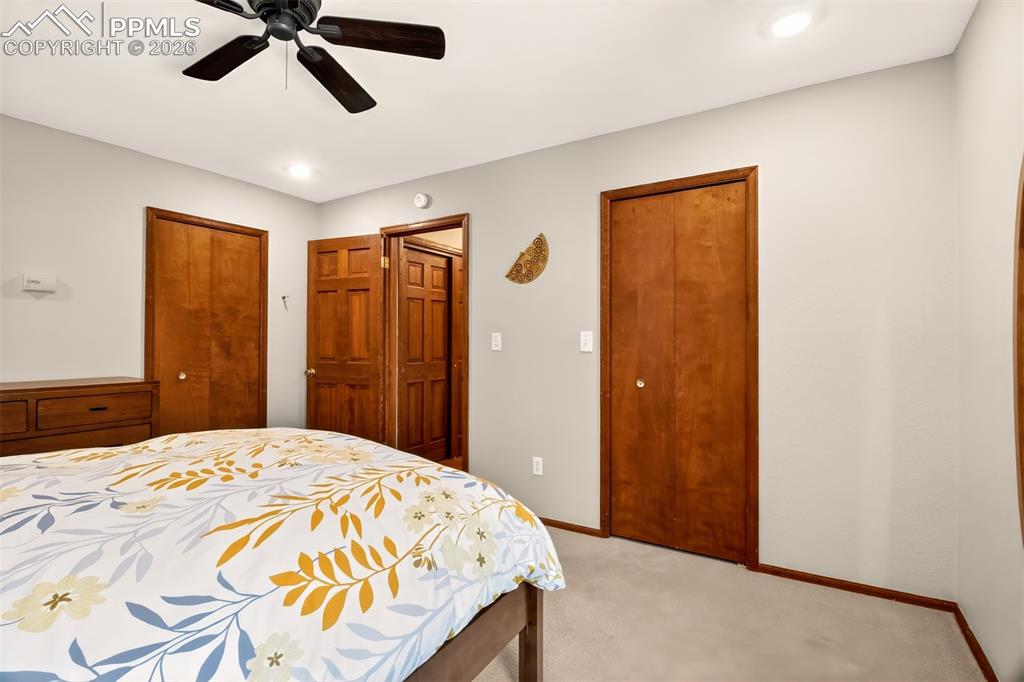 Image 8 of 50: Living room with hardwood flooring, vaulted wood beamed ceilings, a Lopi wo