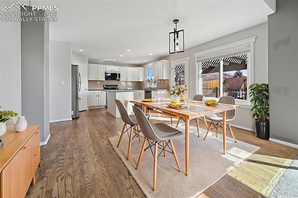 Image 10 of 49: Virtually staged, dining room with walkout