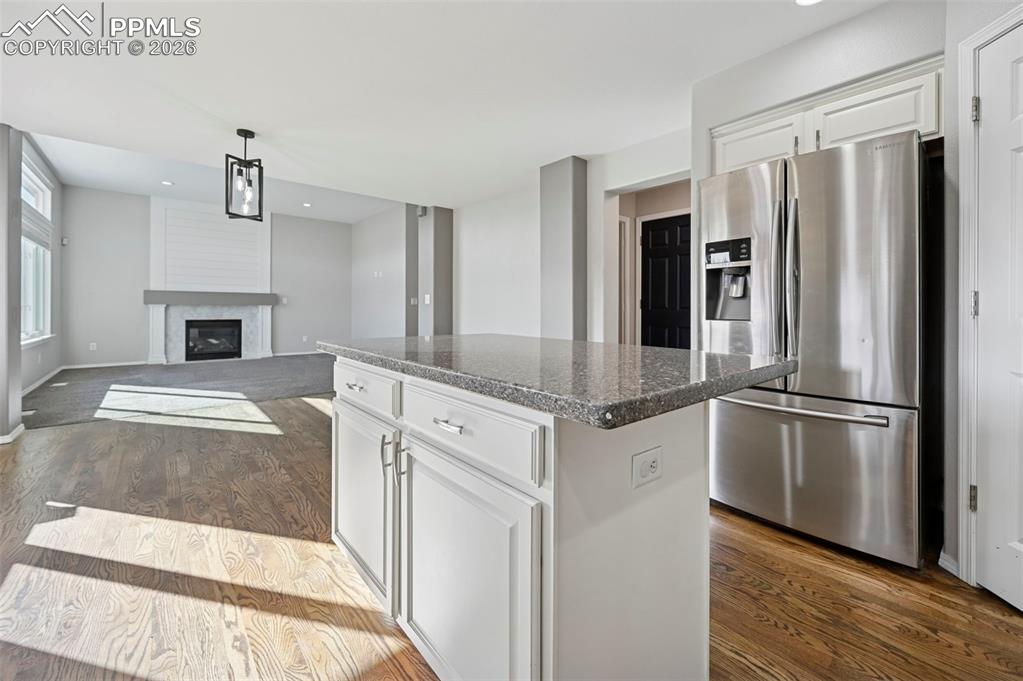 Image 13 of 49: Gorgeous kitchen with white cabinetry, granite countertops, stainless steel