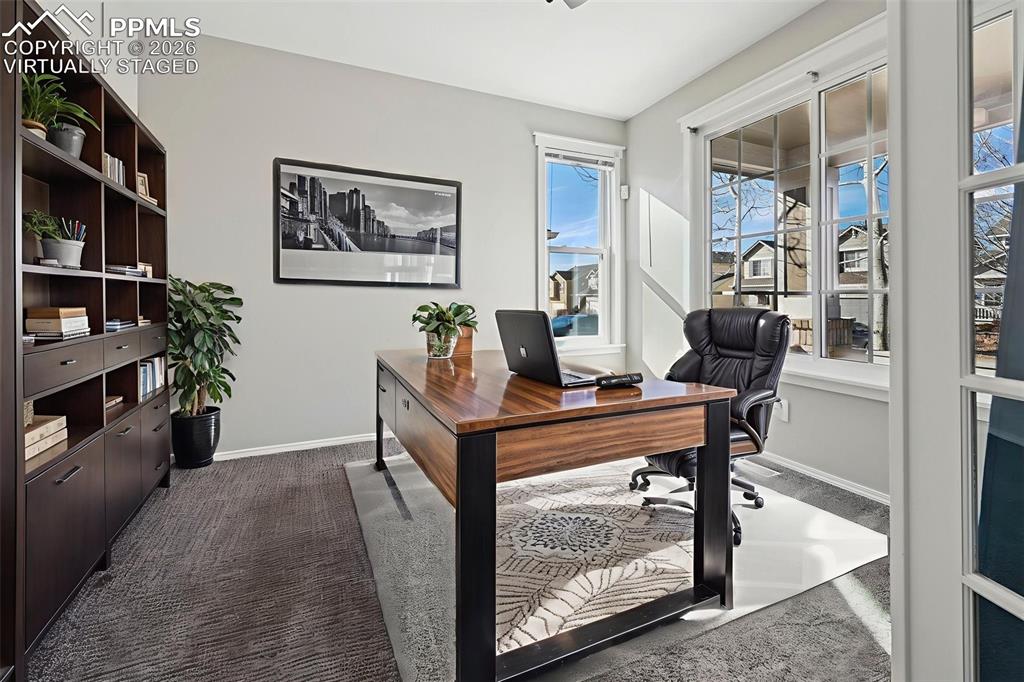 Image 3 of 49: Virtually staged office tucked behind French doors