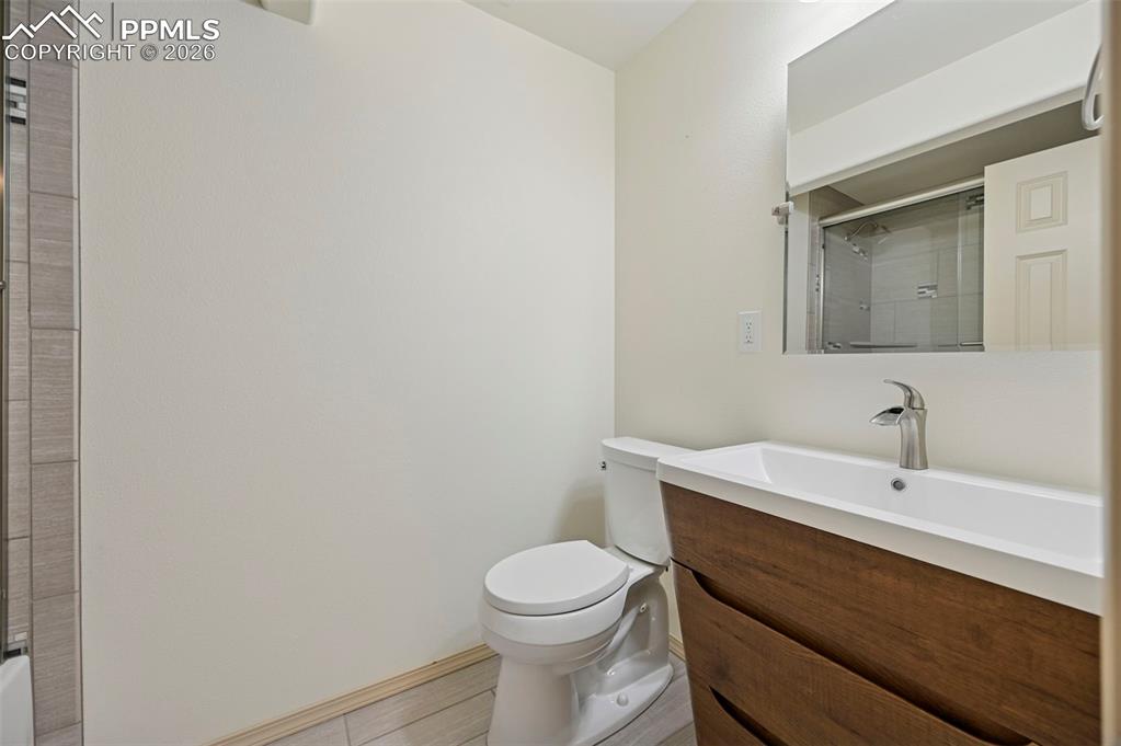 Image 36 of 49: Basement full bathroom with designer cabinetry