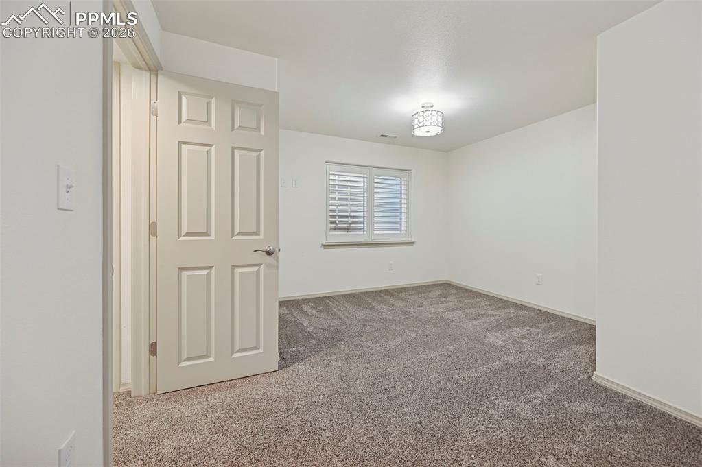 Image 38 of 49: Unstaged basement bedroom