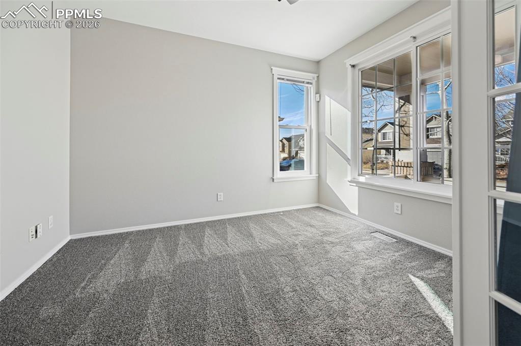 Image 4 of 49: Unstaged Office tucked behind French doors