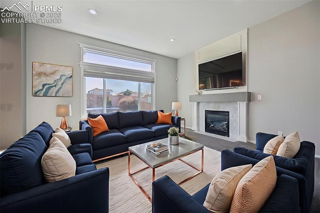 Image 5 of 49: Virtually staged living room with beautiful fireplace