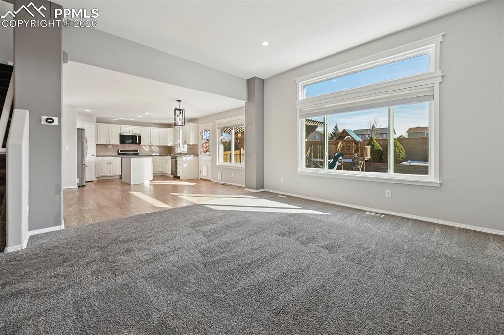Image 8 of 49: Living room, overlooking gorgeous kitchen with hardwood floors