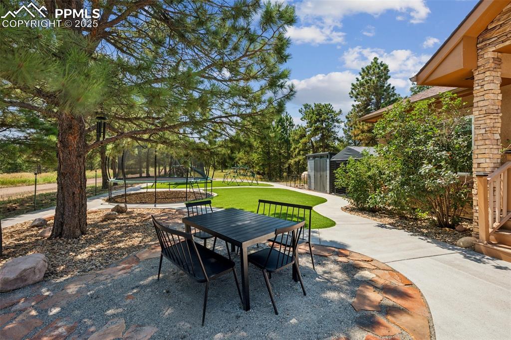 Image 35 of 49: Front Patio w/ Playground