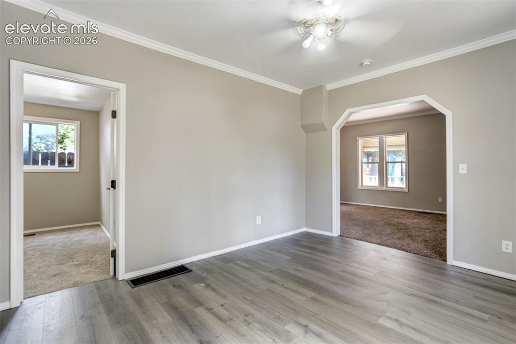 Image 13 of 28: Interior space featuring wood-finish flooring, light neutral wall paint, an