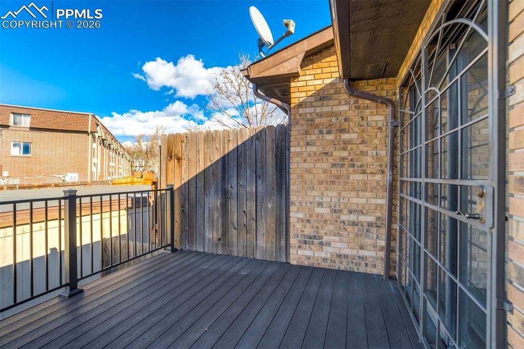 Image 33 of 37: The property features a private outdoor deck with dark composite decking an