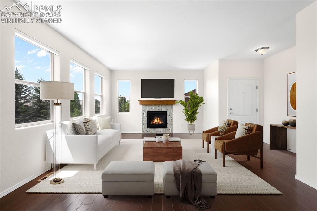 Image 3 of 37: Virtually Staged. Living area featuring wood finished floors and a gas fire