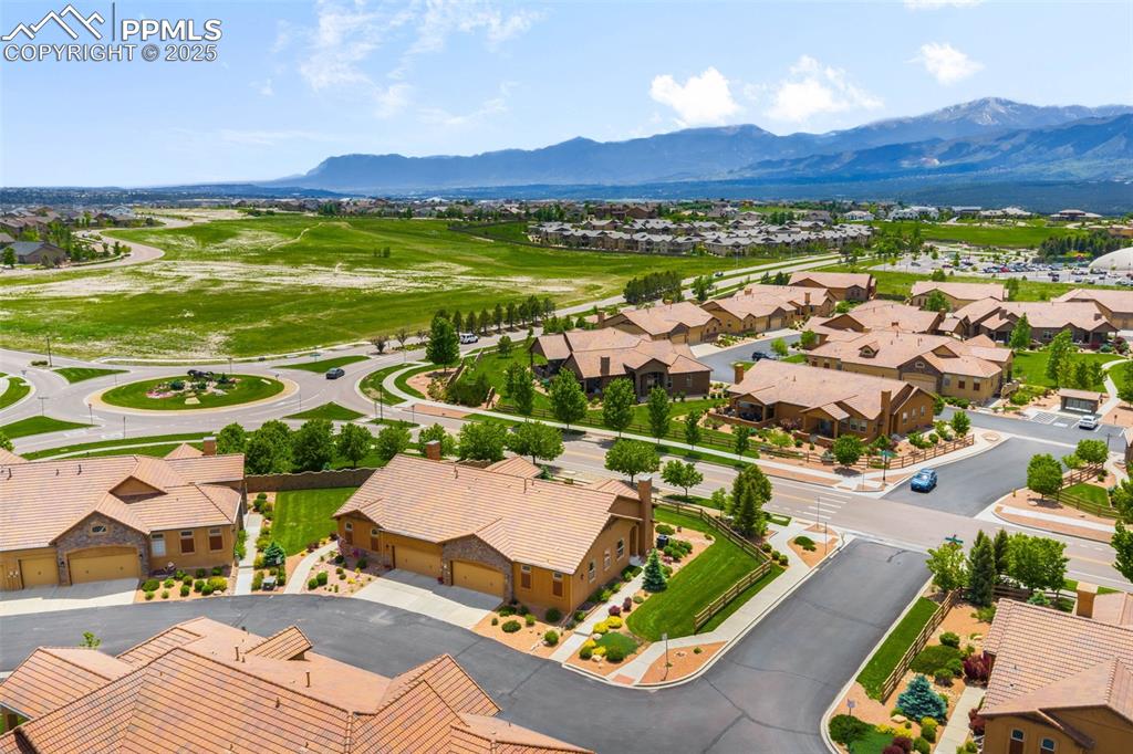 Image 35 of 37: Aerial view of residential area with a mountainous background