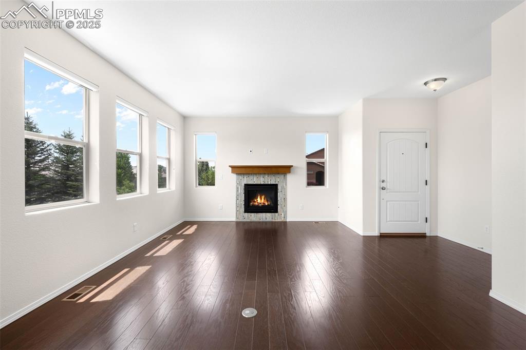 Image 4 of 37: Living area featuring wood finished floors and a gas fireplace