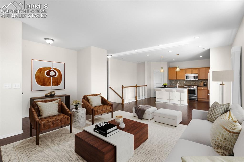 Image 5 of 37: Virtually Staged. Living room featuring wood finished floors