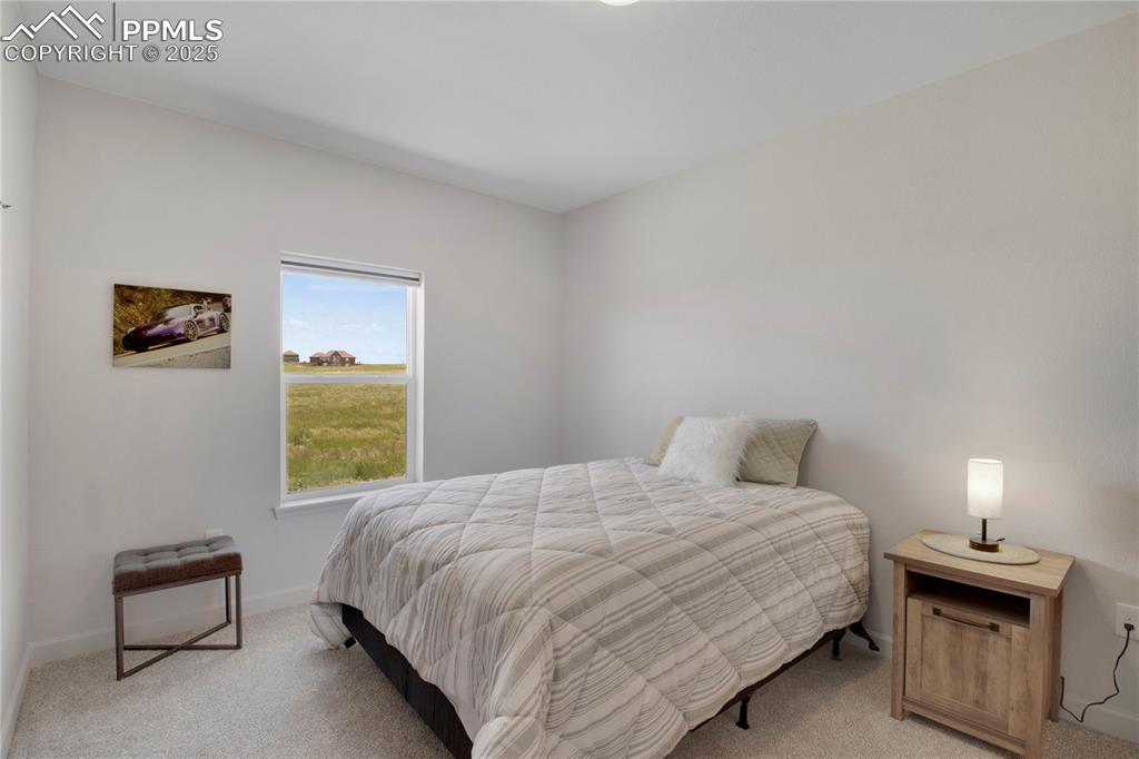 Image 20 of 25: Bedroom #2 featuring light carpet and baseboards