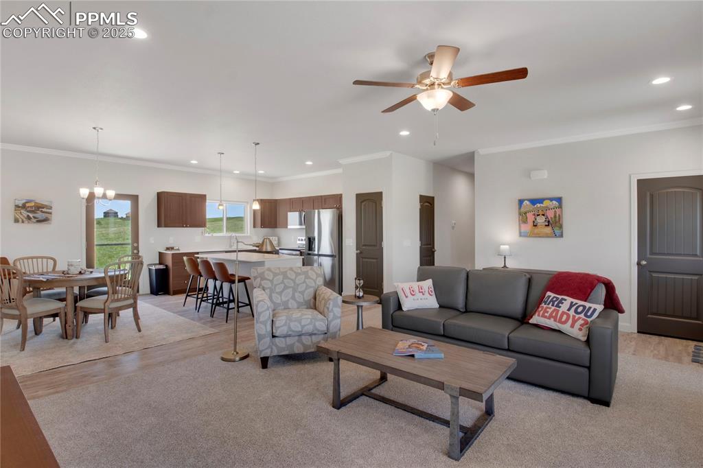 Image 4 of 25: Living room with recessed lighting, ornamental molding, a ceiling fan, and