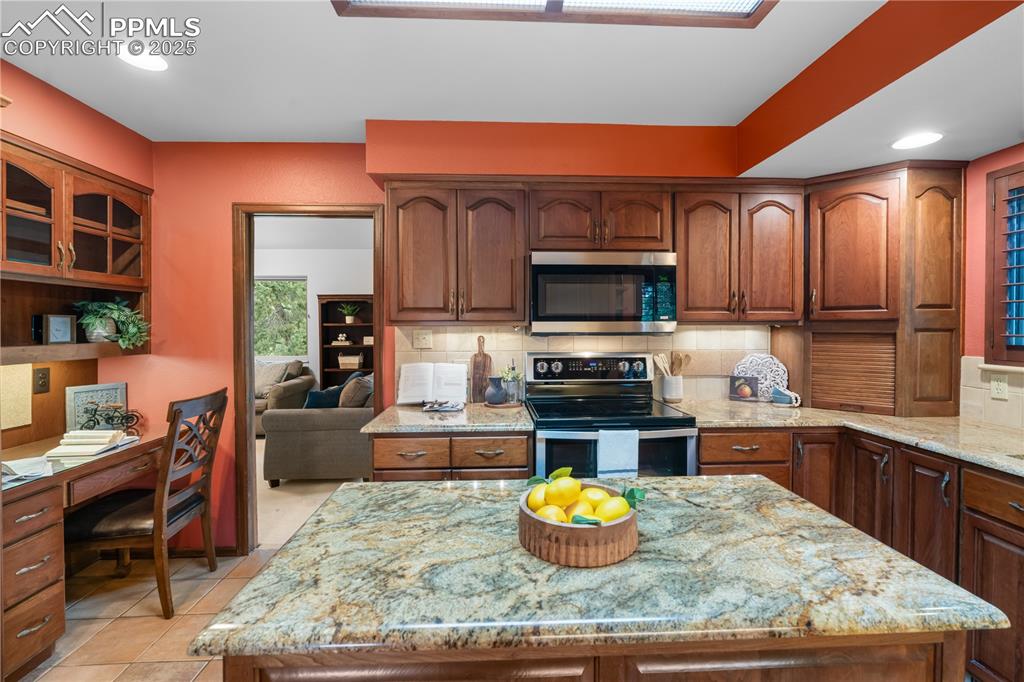 Image 11 of 44: Large kitchen island makes cooking a joy.