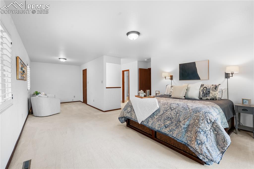 Image 16 of 44: Primary bedroom with sitting area